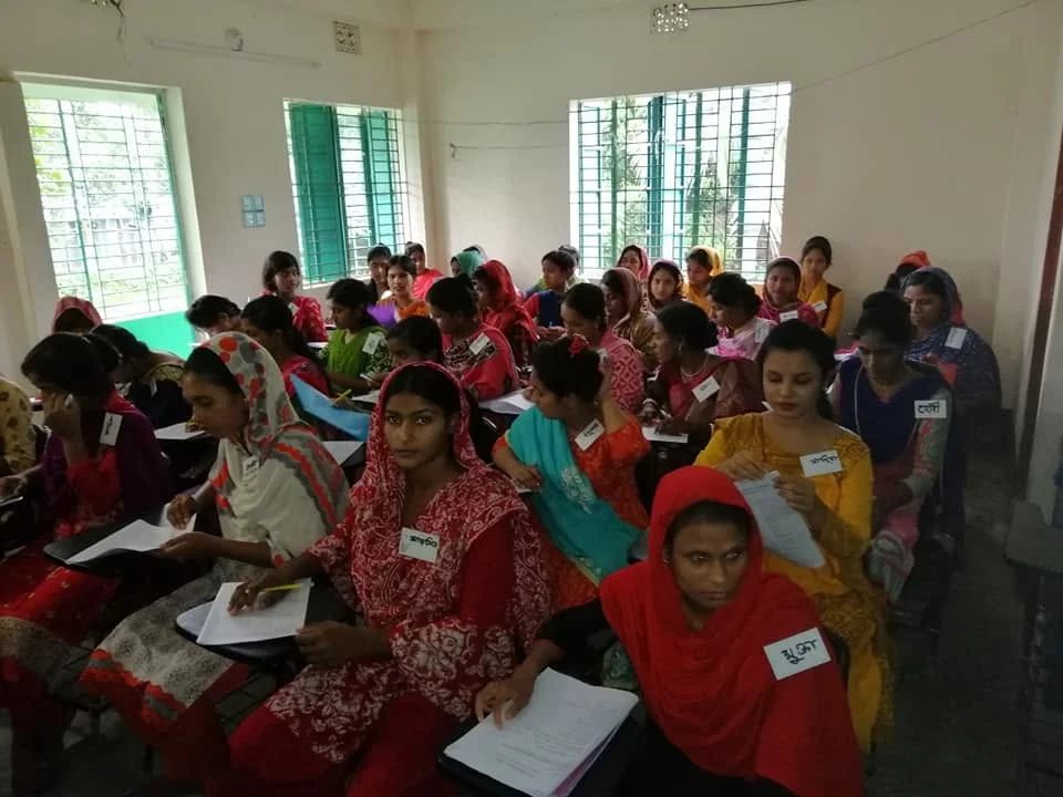 Trainees seated with notebooks and name tags on the first day of a course