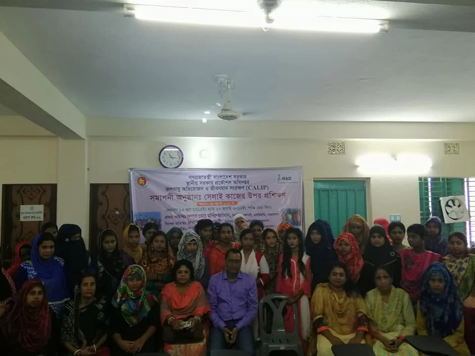Trainees and staff gathered for the closing of a sewing training course