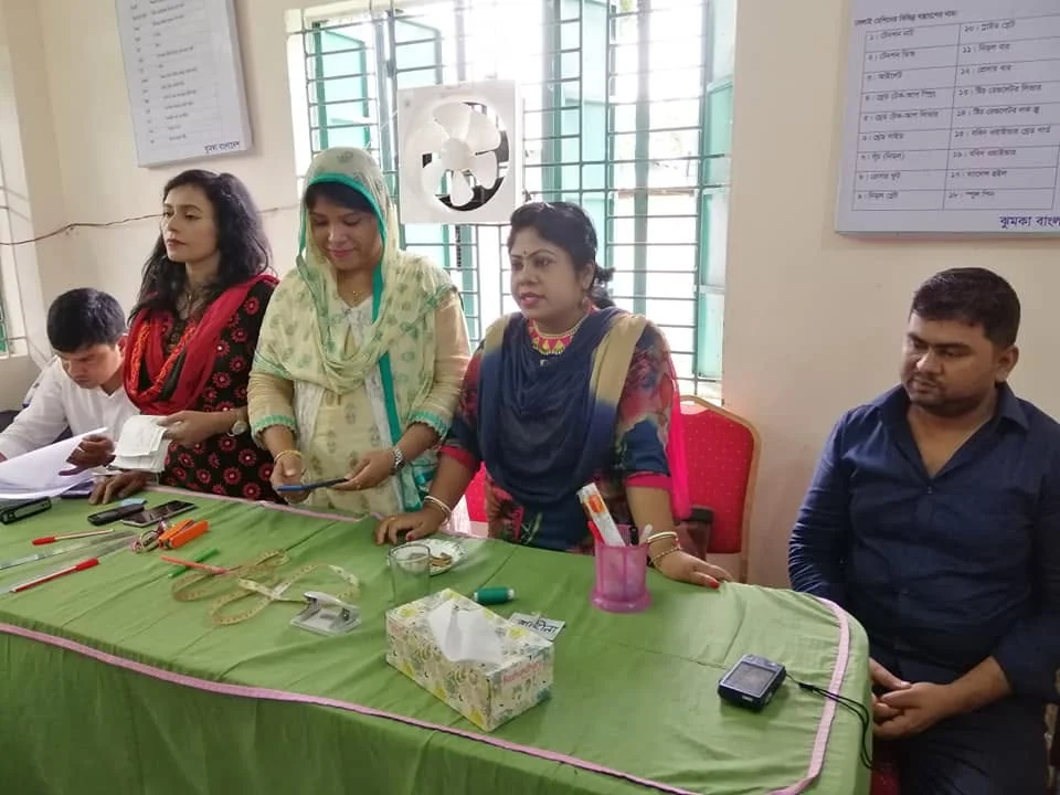 Guests and staff seated at the front table during a training programme