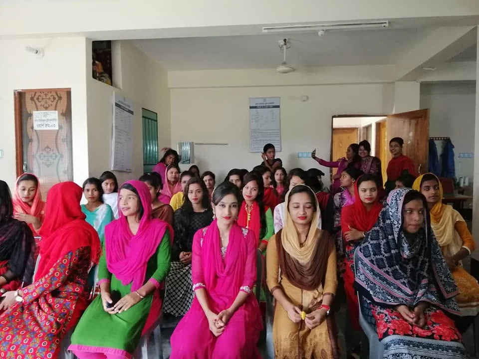 Young women seated together at a programme at the training centre
